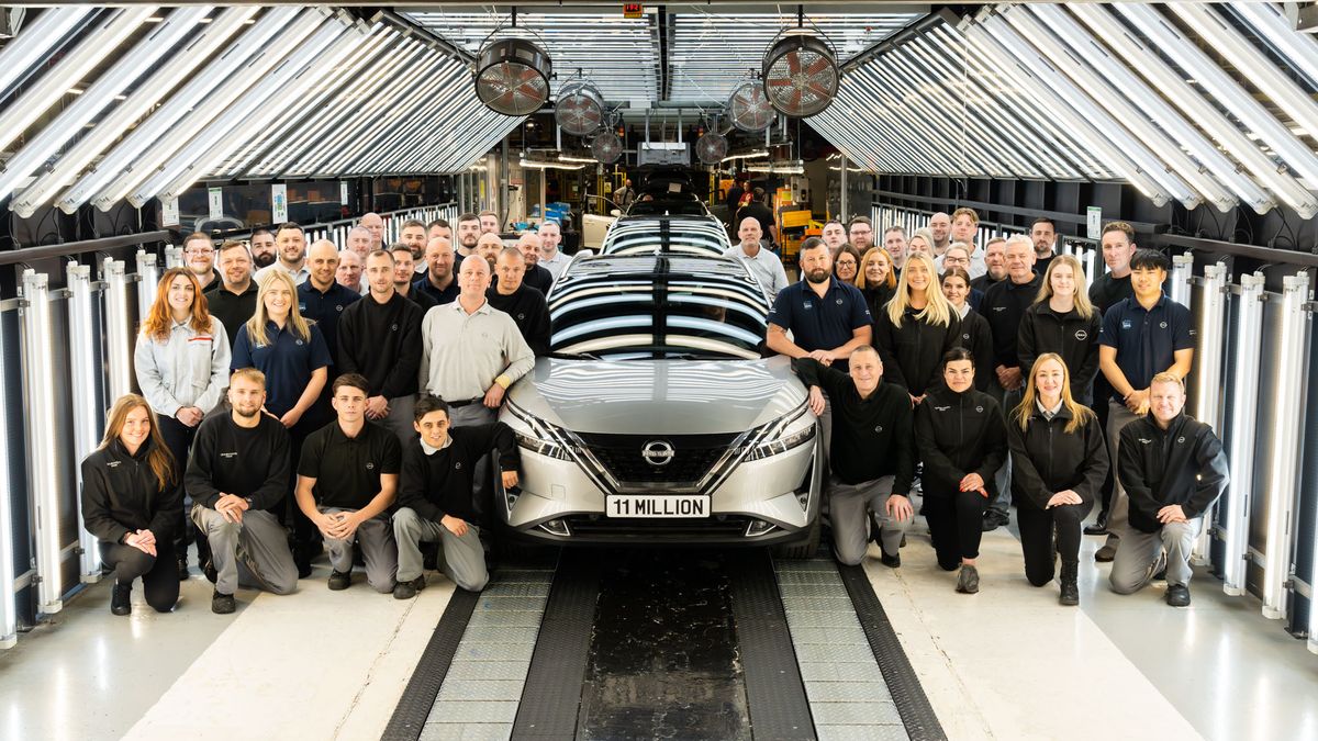 Workers at the Nissan Sunderland UK assembly plant pose with 11 millionth vehicle built at the facility.