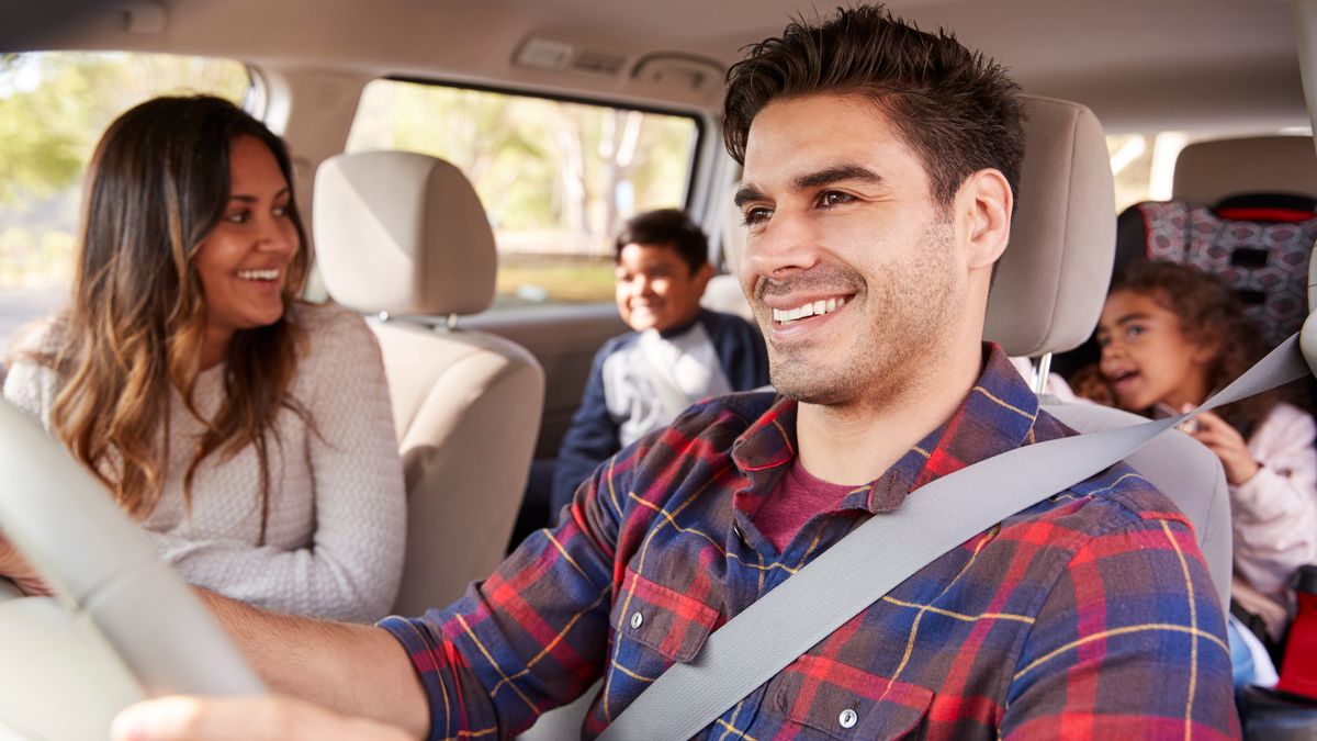 A family driving and wearing seat belts.