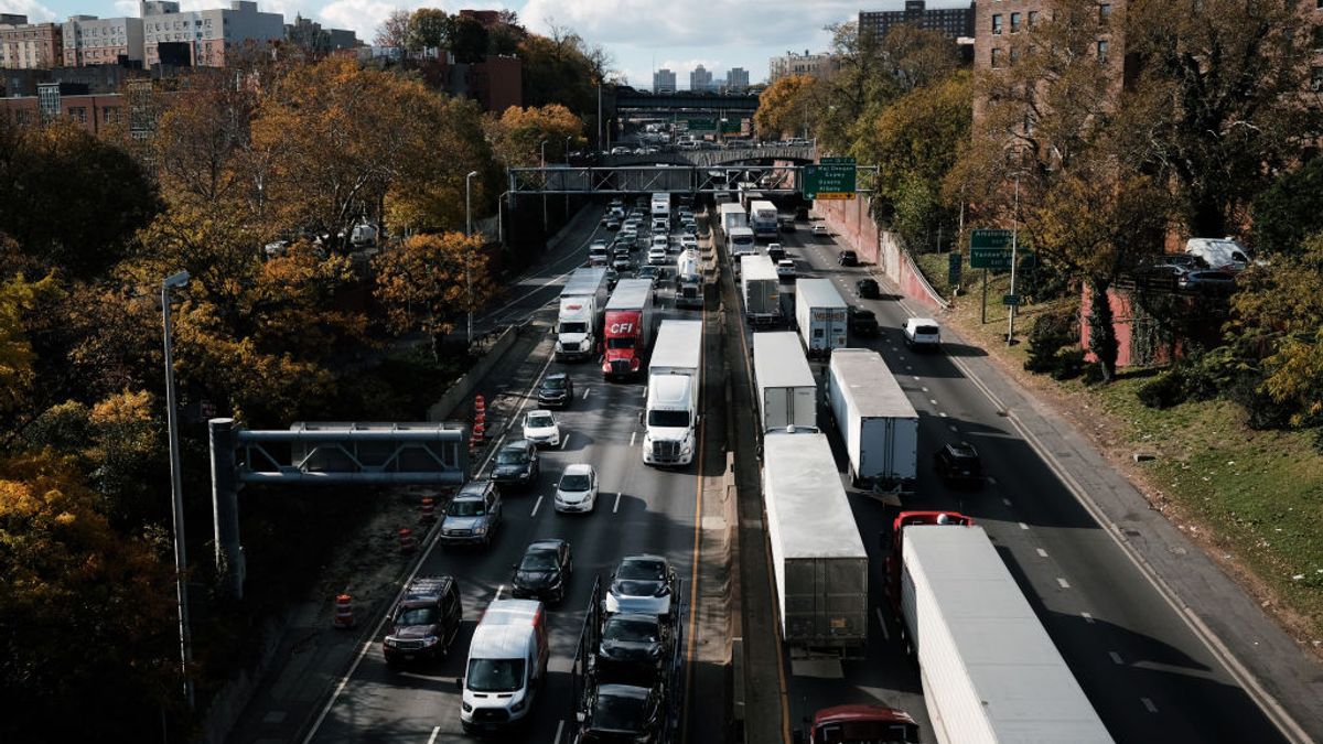Cars and trucks move along the Cross Bronx Expressway in both directions.