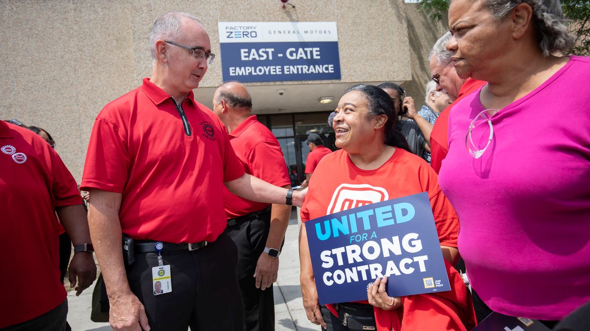 United Auto Workers President Shawn Fain speaks with General Motors workers.