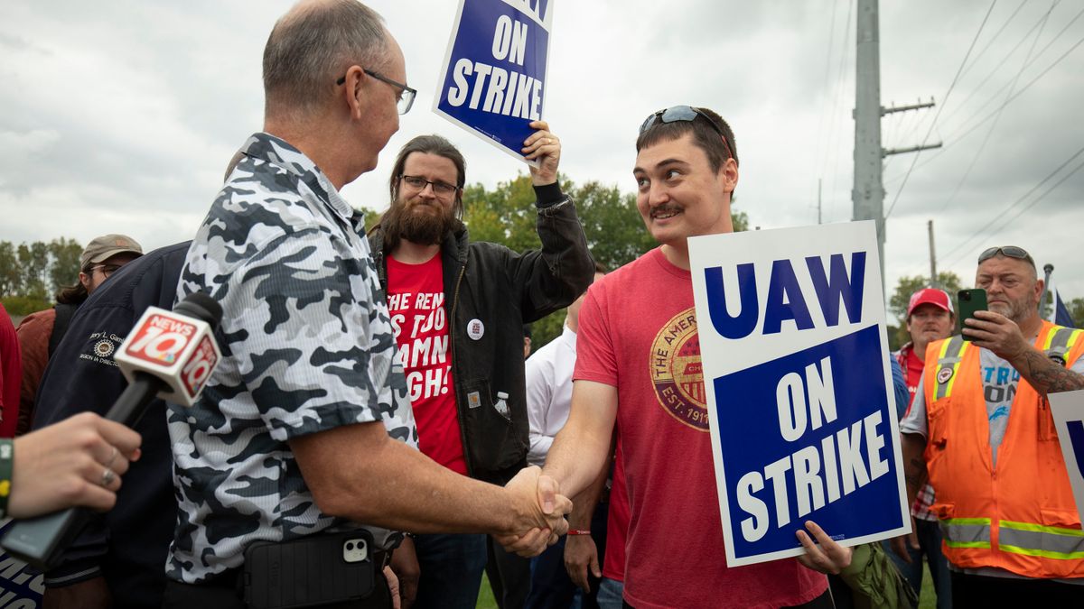 UAW President Shawn Fain greets striking union members outside of GM's Lansing Delta Assembly Plant in Michigan.