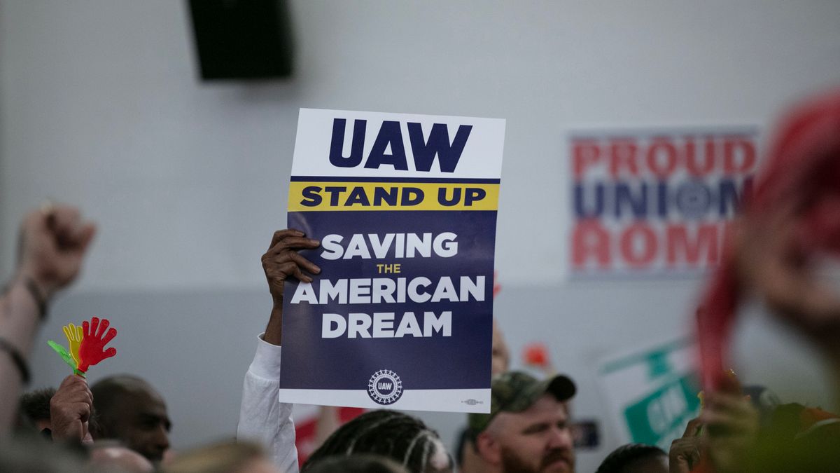 United Auto Workers members attend a rally.