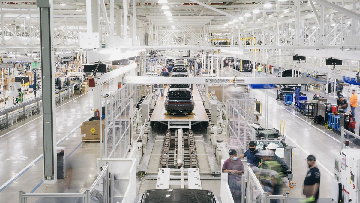 Rivian R1S SUVs on an assembly line.