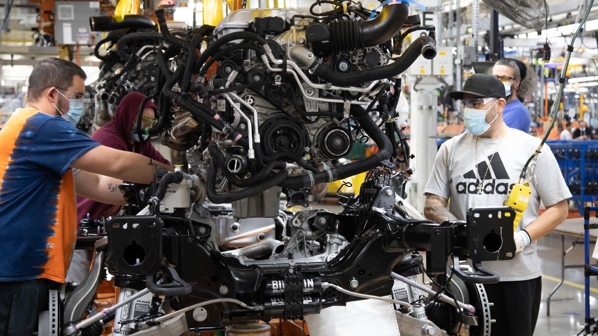 Workers at the Sterling Heights Assembly Plant install a V-8 engine on the chassis of the Ram 1500 pickup