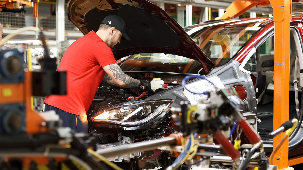 A Stellantis employee assembles a Chrysler Pacifica Hybrid.